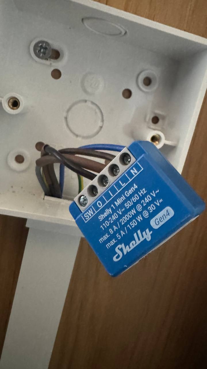 Shelly smart control module installed neatly behind a wall switch